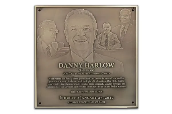 Bronze hall of fame plaque with a photo collage of the honoree