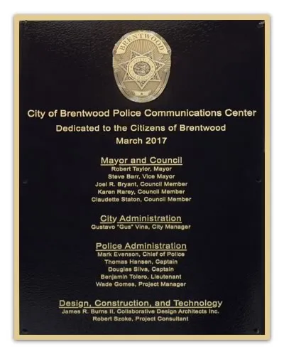 Bronze dedication plaque with black leather textured background and framed photo