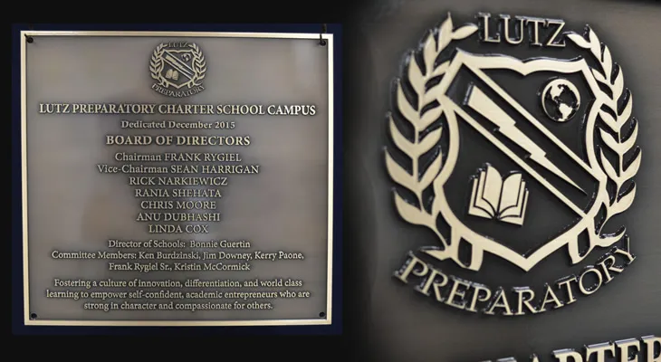 School building dedication plaque listing board of directors, administrators, and faculty