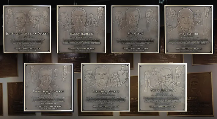 Hall of fame wall with rows of matching bronze plaques and metal letters