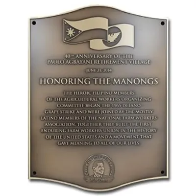 Curved plaque with raised graphic and logo on smooth bronze oxide background