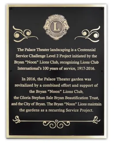 Traditional cast bronze dedication plaque with raised text and decorative line art
